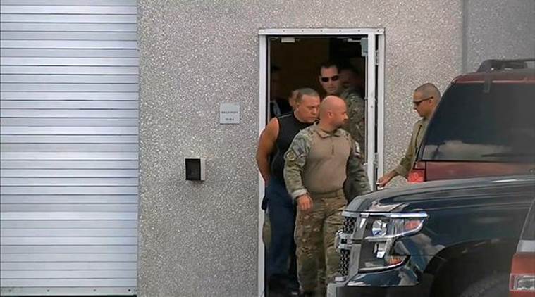   This image capture of a video provided by WPLG-TV shows FBI agents escorting Cesar Sayoc, in sleeveless shirt, to Miramar on Friday. (Via AP) 