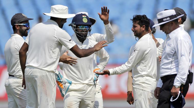 Indian cricketer Kuldeep Yadav celebrates after the dismissal of West Indies' Roston Chase during the third day of the first cricket test match between India and West Indies