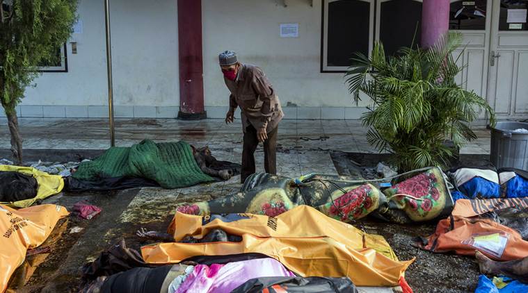 Man searches among dead bodies after tsunami in Indonesia