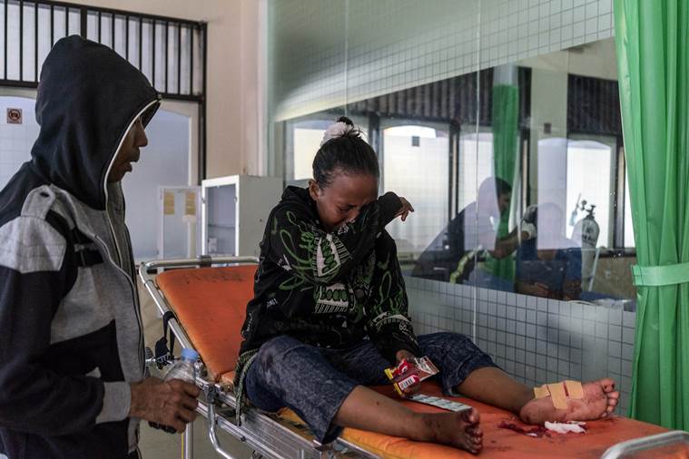 Woman cries in Indonesia hospital while receiving treatment