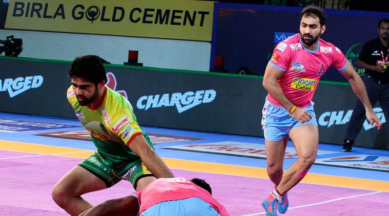 Tamil Thalaivas' K. Prapanjan, in blue and yellow jersey, is pinned down by  players of Patna Pirates during their Vivo Pro Kabaddi league match in  Mumbai, India, Saturday, Aug. 26, 2017. (AP