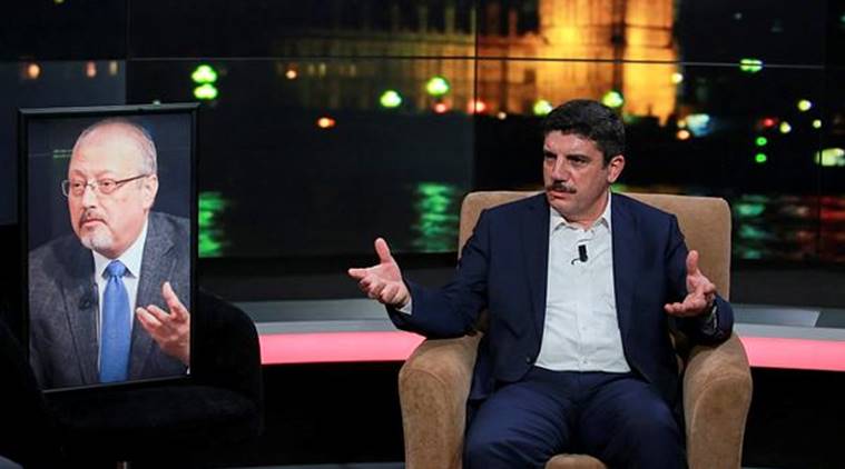 Yasin Aktay, an advisor to Turkey's President Recep Tayyip Erdogan and a good friend sits next to an empty chair with a picture of Saudi writer Jamal Khashoggi placed on it, speaks during a live television program for London-based TV station al-Hewar, in Istanbul, late Thursday. (AP)