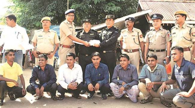 Indian and Myanmar officials with the Rohingya men in Moreh, Manipur, Thursday.  (Source: Reuters)