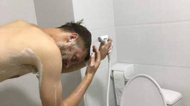 shower too low, tourist complaints of shower too low, viral picture, viral shower picture, tourist shower picture, indian express, indian express news