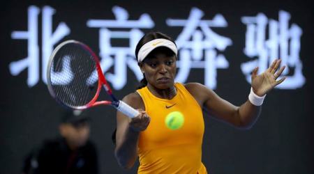 Sloane Stephens of the United States plays a return shot while competing against Dominika Cibulkova of Slovakia in their third round women's singles match in the China Open at the National Tennis Stadium in Beijing