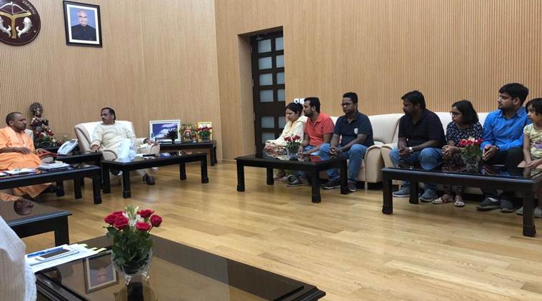 Uttar Pradesh Chief Minister Yogi Adityanath meets Vivek Tiwari's wife at his residence on Monday.