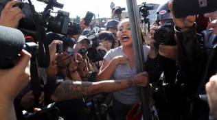 Tijuana protesters chant 'Out!' at migrants camped in city