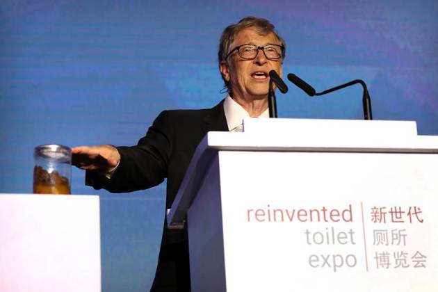 Bill Gates gives a speech with a jar of faeces next to him on the future of toilets