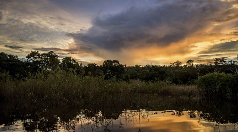 Sunset on the Tapajós River, deep in the Amazon rainforest, in Brazil.