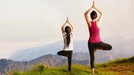 Mother and daughter doing yoga at top of mountain no alt set