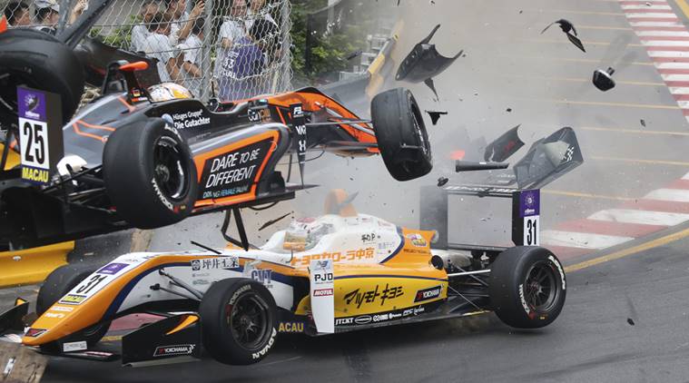 Teenage driver Sophia Floersch of Germany, top, goes over Japanese driver Sho Tsuboi's car while flying off the track at high speed on a tight right-hand bend on lap four at the Macau grand Prix