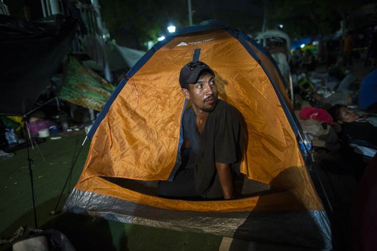 Joel Eduardo Espinar looks out from his family's tent 