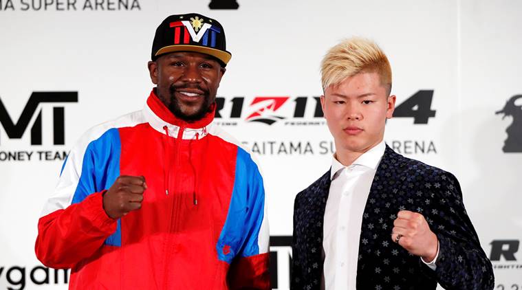 Undefeated boxer Floyd Mayweather Jr. of the U.S. poses for a photograph with his opponent Tenshin Nasukawa during a news conference to announce he is joining Japanese Mixed Martial Arts promotional company Rizin Fighting Federation, in Tokyo, Japan