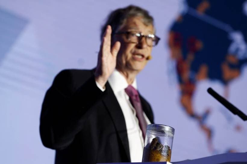 Bill Gates gives a speech with a jar of faeces next to him on the future of toilets