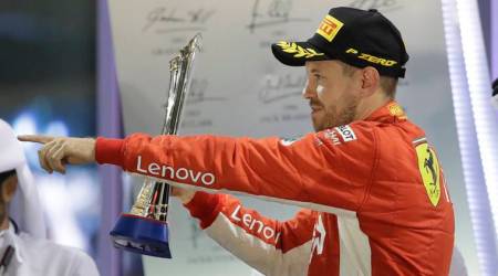 Ferrari driver Sebastian Vettel of Germany celebrates his second place on the podium after the Emirates Formula One Grand Prix at the Yas Marina racetrack in Abu Dhabi, United Arab Emirates