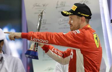 Ferrari driver Sebastian Vettel of Germany celebrates his second place on the podium after the Emirates Formula One Grand Prix at the Yas Marina racetrack in Abu Dhabi, United Arab Emirates