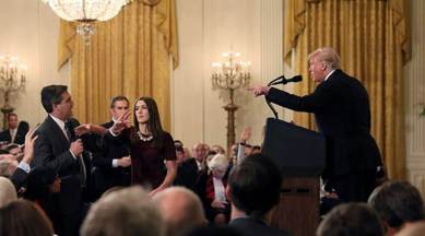 A White House staff member reaches for the microphone held by CNN's Jim Acosta as he questions US President Donald Trump during a news conference following Tuesday's midterm US congressional elections at the White House in Washington on Wednesday. (Reuters)