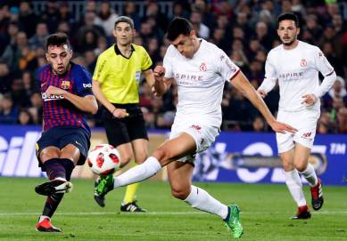 FC Barcelona's Munir El Haddadi, left, kicks the ball to score during a Spanish Copa del Rey soccer match between FC Barcelona and Cultural Leonesa at the Camp Nou stadium in Barcelona, Spain