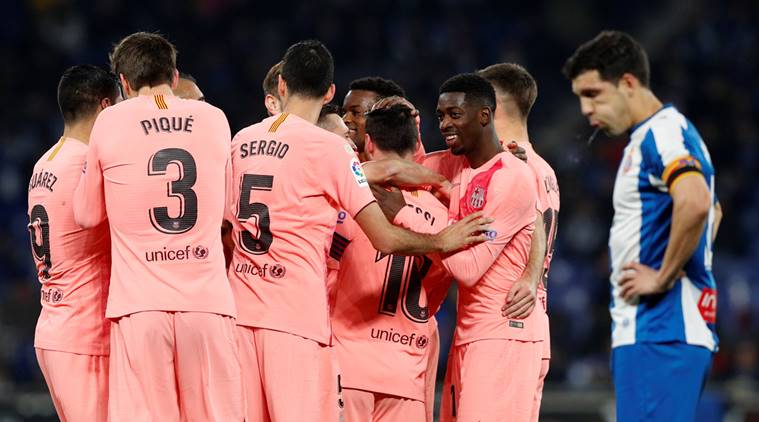 Barcelona's Lionel Messi celebrates scoring their fourth goal against Espanyol with team mates