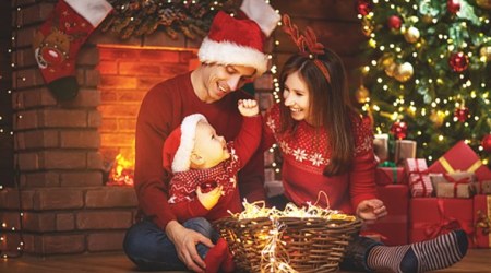 happy family mother father and baby at christmas tree  at home