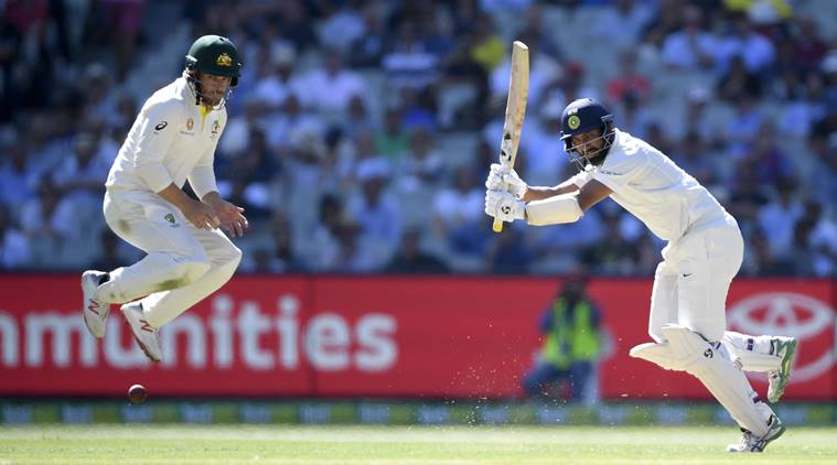 Australia's Aaron Finch, left, jumps to avoid a shot from India's Cheteshwar Pujara during play on day one of the third cricket test between India and Australia in Melbourne, Australia