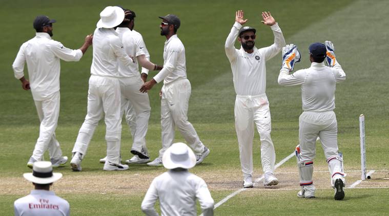 Indian players celebrate the dismissal of Australia's Tim Paine on the final day of the first cricket test between Australia and India in Adelaide, Australia