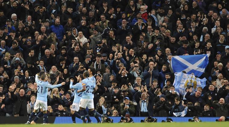 Manchester City's Ilkay Gundogan celebrates with teammates after scoring his side's third goal during the English Premier League soccer match between Manchester City and Bournemouth at Etihad stadium in Manchester