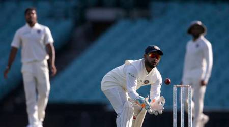 India's Rishabh Pant, center, catches the ball during their tour cricket match against Cricket Australia XI in Sydney