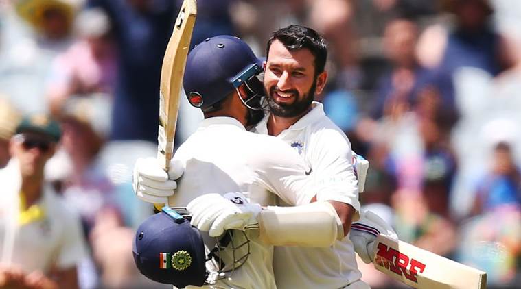 India's Cheteshwar Pujara celebrates after reaching a century during the first cricket test between Australia and India in Adelaide, Australia