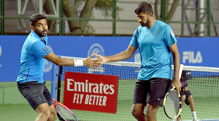 Indian pair Rohan Bopanna (R) and Divij Sharan celebrate after defeating Radu Albot-Malek Jaziri pair, in the Men's double of the first round on Day two during the Tata Open Maharashtra at Mhalunge Balewadi Tennis Stadium