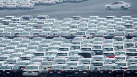 A file photo of newly manufactured cars are seen at the automobile terminal in the port of Dalian