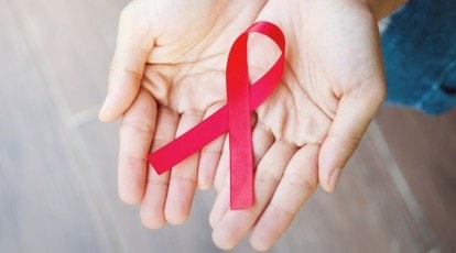 One line drawing of a hand with red ribbon. aids. Hand's people show symbol HIV  Aids