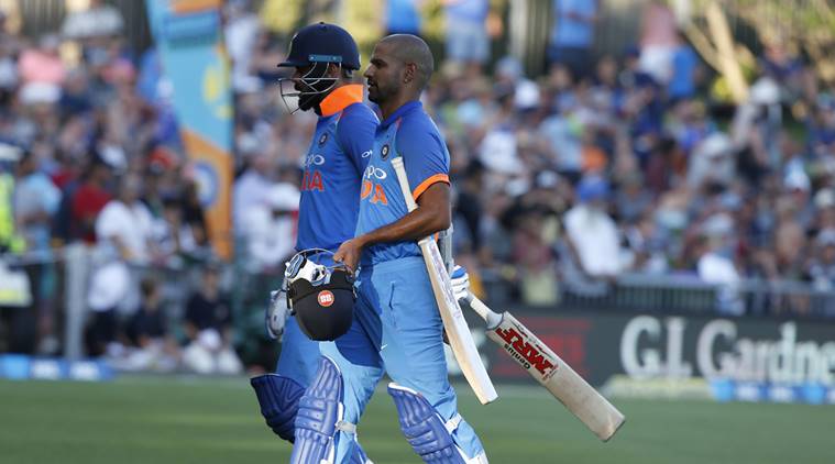India's Virat Kohli, left, and teammate Shikhar Darma leave the pitch for a short time during a one day international between New Zealand and India in Napier, New Zealand