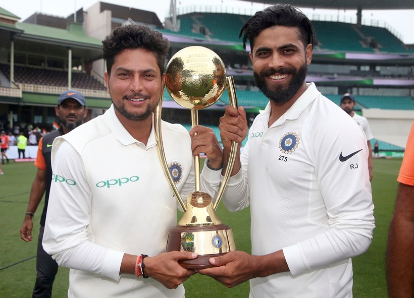 India's Kuldeep Yadav, left, and Ravindra Jadeja hold the Border-Gavaskar Trophy as they celebrate their series win over Australia after play was called off on day 5 of their cricket test match in Sydney