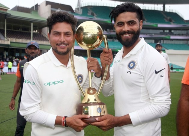 India's Kuldeep Yadav, left, and Ravindra Jadeja hold the Border-Gavaskar Trophy as they celebrate their series win over Australia after play was called off on day 5 of their cricket test match in Sydney