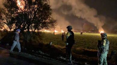 Military personnel watch as flames engulf an area after a ruptured fuel pipeline exploded, in the municipality of Tlahuelilpan, Hidalgo, Mexico, near the Tula refinery of state oil firm Petroleos Mexicanos (Pemex), January 18, 2019 in this handout photo provided by the National Defence Secretary (SEDENA). National Defence Secretary/Handout via REUTERS ATTENTION EDITORS - THIS IMAGE HAS BEEN SUPPLIED BY A THIRD PARTY.