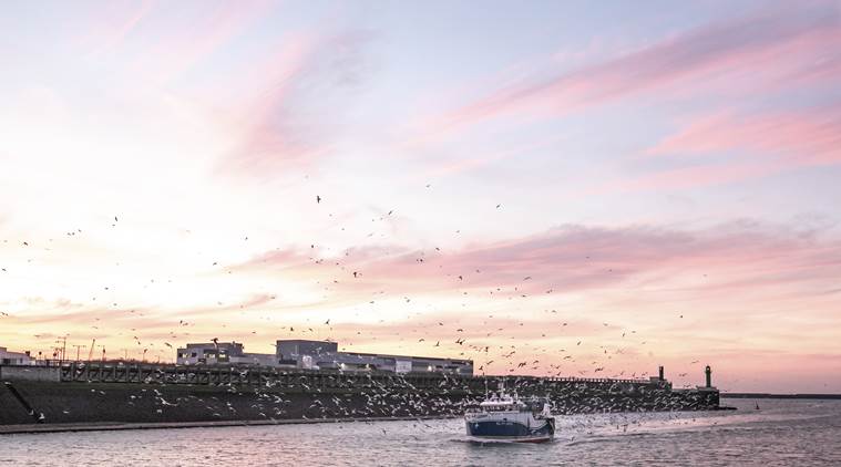 A fishing boat enters the port of Boulogne-sur-Mer, France, across the English Channel from Britain.