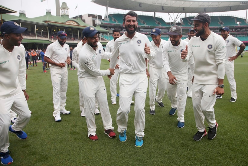 India's Virat Kohli, right, encourages Cheteshwar Pujara, center, as the team dance as they celebrate their series win over Australia after play was called off on day 5 of their cricket test match in Sydney