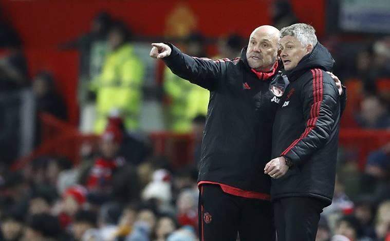 Manchester United coach Mike Phelan and interim manager Ole Gunnar Solskjaer, right, gesture on the touchline during the match against Burnley, during their English Premier League soccer match at Old Trafford in Manchester, England