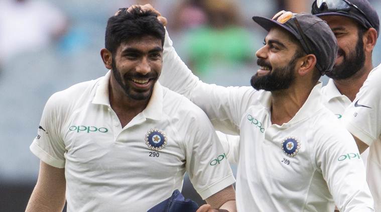 India's captain Virat Kohli, right, celebrates Jasprit Bumrah, left, after Bumrah got the wicket of Australia's Shaun Marsh during play on day three of the third cricket test between India and Australia in Melbourne, Australia