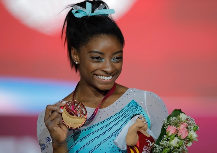 Gold medallist and four-times All-Around world champion Simone Biles of the U.S., poses on the podium after the Women's All-Around Final of the Gymnastics World Chamionships at the Aspire Dome in Doha, Qatar