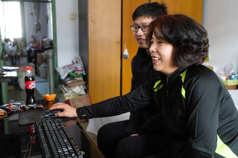 a professional blogger, plays the video game "Chinese Parents" with his mother at home in Qinhuangdao, China