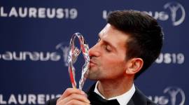 Novak Djokovic poses after winning the sportsman of the year award