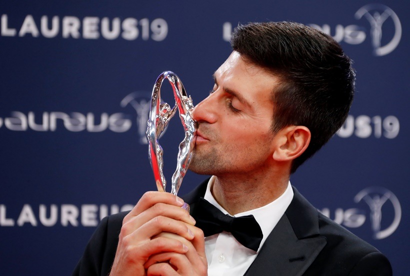 Novak Djokovic poses after winning the sportsman of the year award