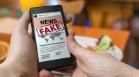 Man is holding smartphone and reading fake news on internet. Propaganda, disinformation and hoax concept. IIIT Delhi, indraprashth institute, IP university, ip admissions, iiit delhi admissions, iiit admissionm start up india, stand up india, recheck news, fact check app, whatsapp messages, whatsapp news, fake news