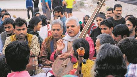 Prahlad Singh Tipaniya (in pink kurta) with fellow artistes during a performance