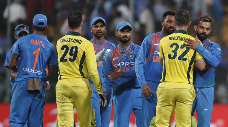 India's captain Virat Kohli, right, hugs Australia's Glenn Maxwell to congratulate him on their win in the second T20 international cricket match between India and Australia in Bangalore
