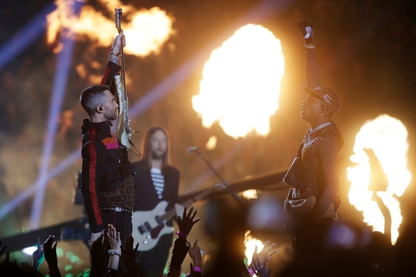 Adam Levine of Maroon 5, left, and Travis Scott salute each other during halftime of the NFL Super Bowl 53 football game between the Los Angeles Rams and the New England Patriots Sunday, Feb. 3, 2019, in Atlanta.
