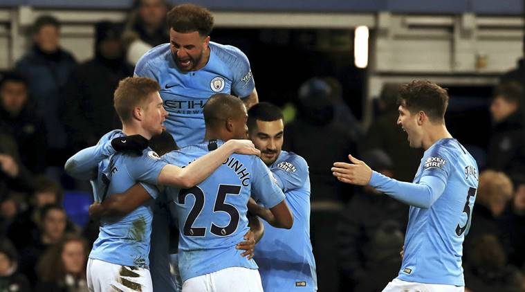 Manchester City's Gabriel Jesus, obscured, celebrates with teammates after scoring his side's second goal of the game against Everton during an English Premier League soccer match at Goodison Park, Liverpool