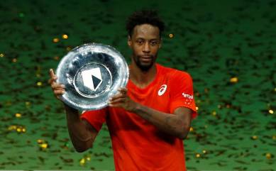 France's Gael Monfils celebrates winning the Rotterdam Open with the trophy